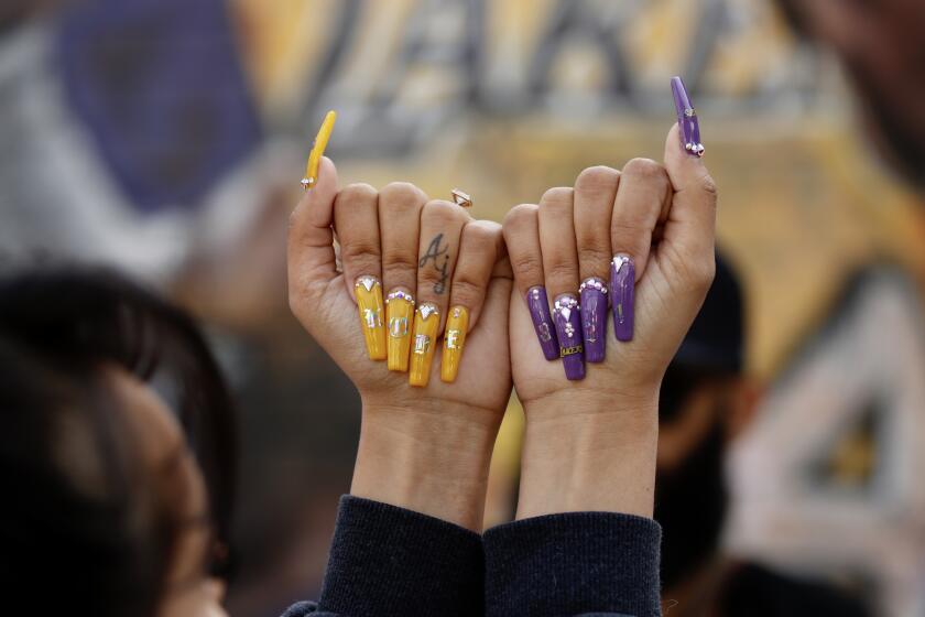 LOS ANGELES CA FEBRUARY 24, 2020 -- Jazmine Jabi shows her nails that she created for the memorial at the Kobe Bryant mural on Lebanon St, just a short distance from Staples Center where the 'Celebration of Life' for Kobe and Gianna Bryant, is being held. (Al Seib / Los Angeles Times)