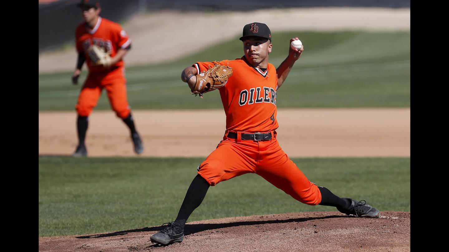 Huntington Beach High starter Eddie Pelc throws against Fountain Valley during the first inning in a Surf League game at Huntington Beach High on Friday, March 15, 2019.