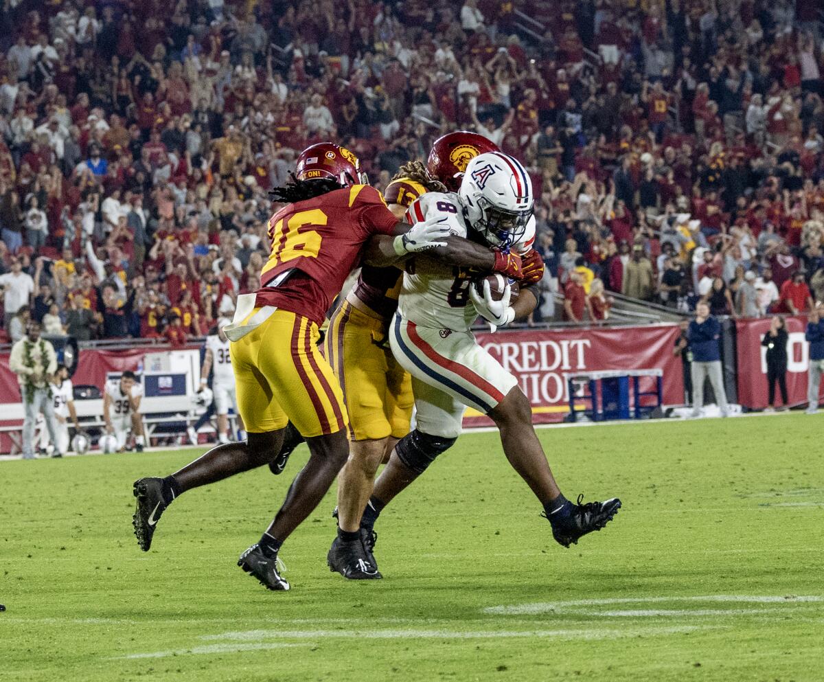 Prophet Brown and Christian Roland-Wallace make a tackle for USC.