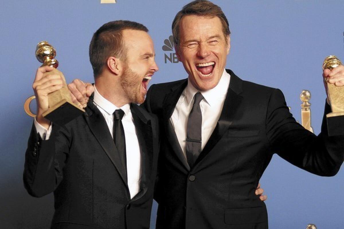 Aaron Paul, left, and Bryan Cranston celebrate the Golden Globe win for "Breaking Bad" and Cranston's win for best actor in a TV drama series.