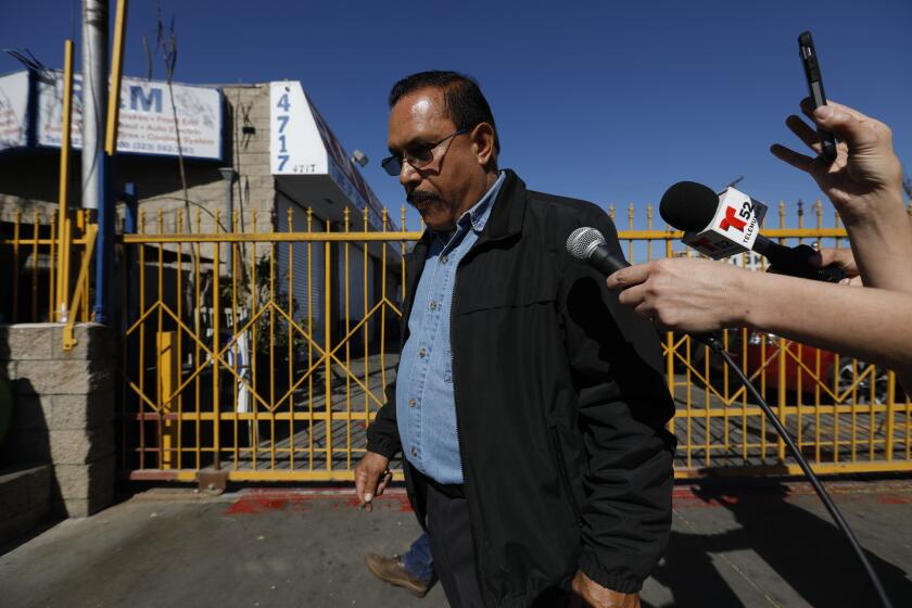 MAYWOOD, CALIF. -- THURSDAY, FEBRUARY 8, 2018: City of Maywood Mayor Ramon Medina is asked questions by the media after investigators with the Los Angeles County District Attorney's Office removed computers and boxes with files from R&M Auto Service owned by Mayor Medina in Maywood, Calif., on Feb. 8, 2018. An official described it as an investigation into accusations of corruption. (Gary Coronado / Los Angeles Times)