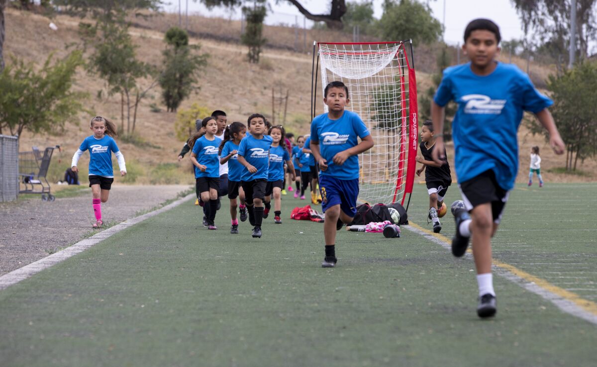 Youth participate in soccer practice earlier this month in National City.