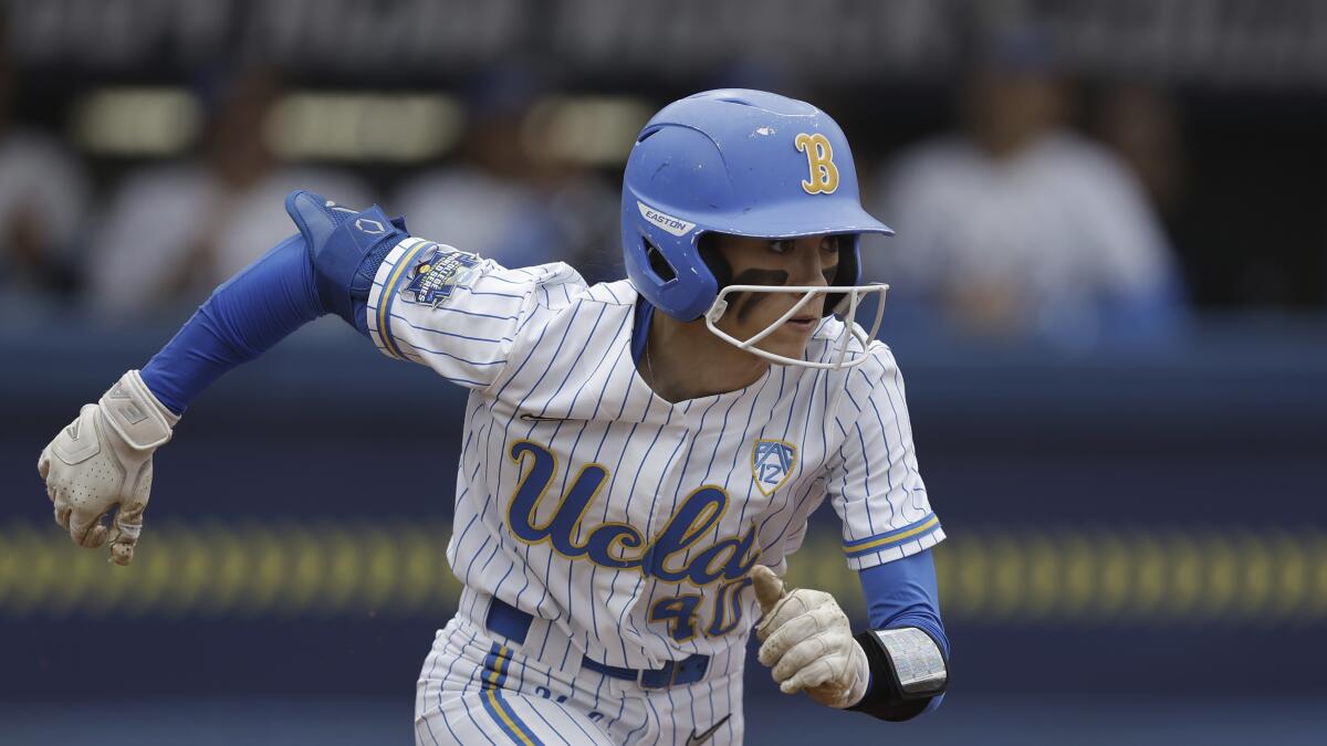 UCLA's Jadelyn Allchin (40) runs to first during an NCAA softball Women's College World Series game.