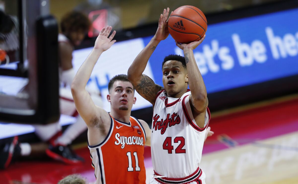 Rutgers guard Jacob Young (42) shoots next to Syracuse guard Joseph Girard III (11) during the second half of an NCAA college basketball game in Piscataway, N.J., Tuesday, Dec. 8, 2020. (AP Photo/Noah K. Murray)