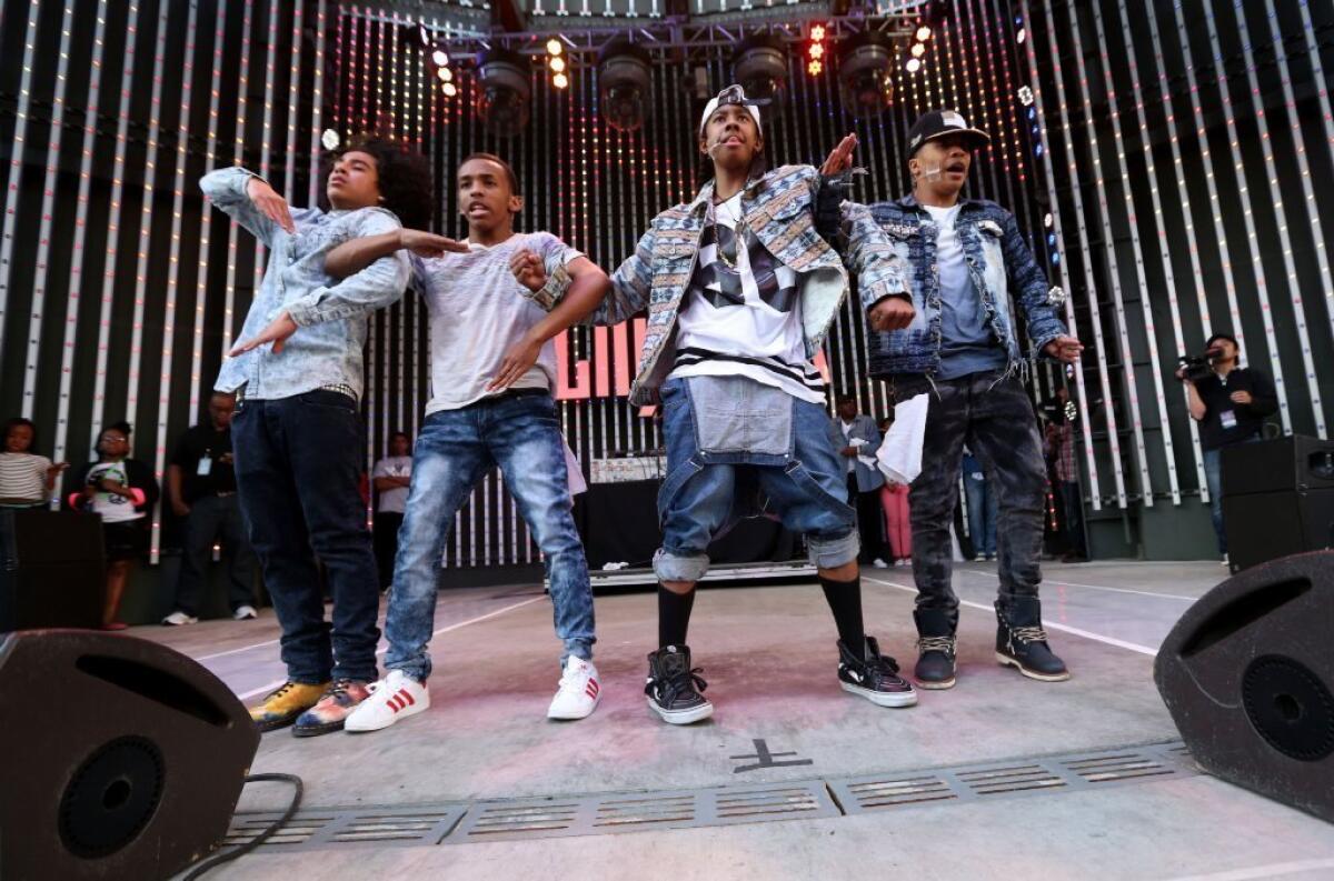Mindless Behavior performs at Universal CityWalk's 5 Towers for the premiere of "All Around The World." The popular entertainment complex will host a free spring concert series.