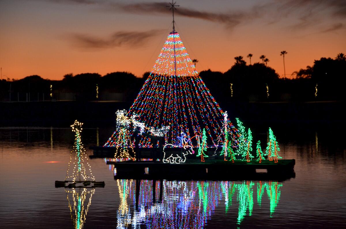 The Newport Dunes lagoon became a holiday light destination with 57 floating trees for the Lighting of the Bay on Friday.