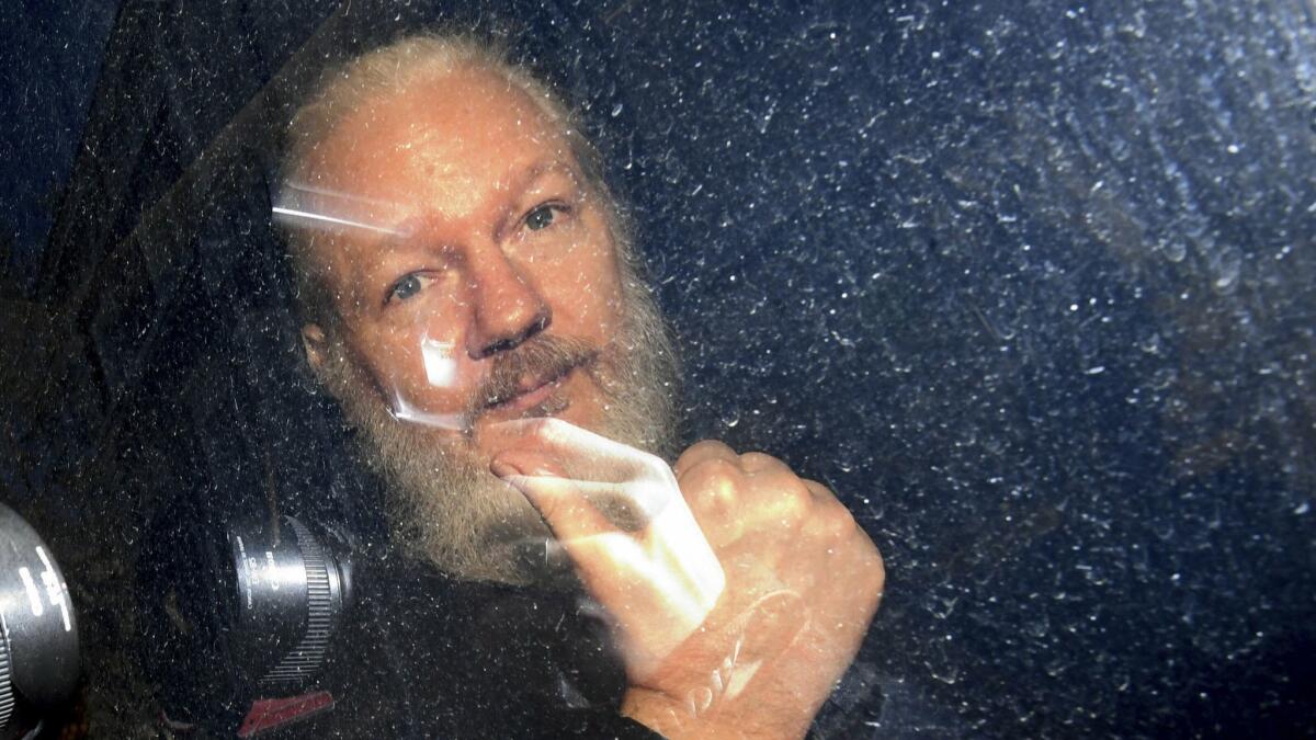 Wikileaks founder Julian Assange gestures as he arrives at Westminster Magistrates' Court in London after being arrested at the Ecuadorean embassy on April 11.