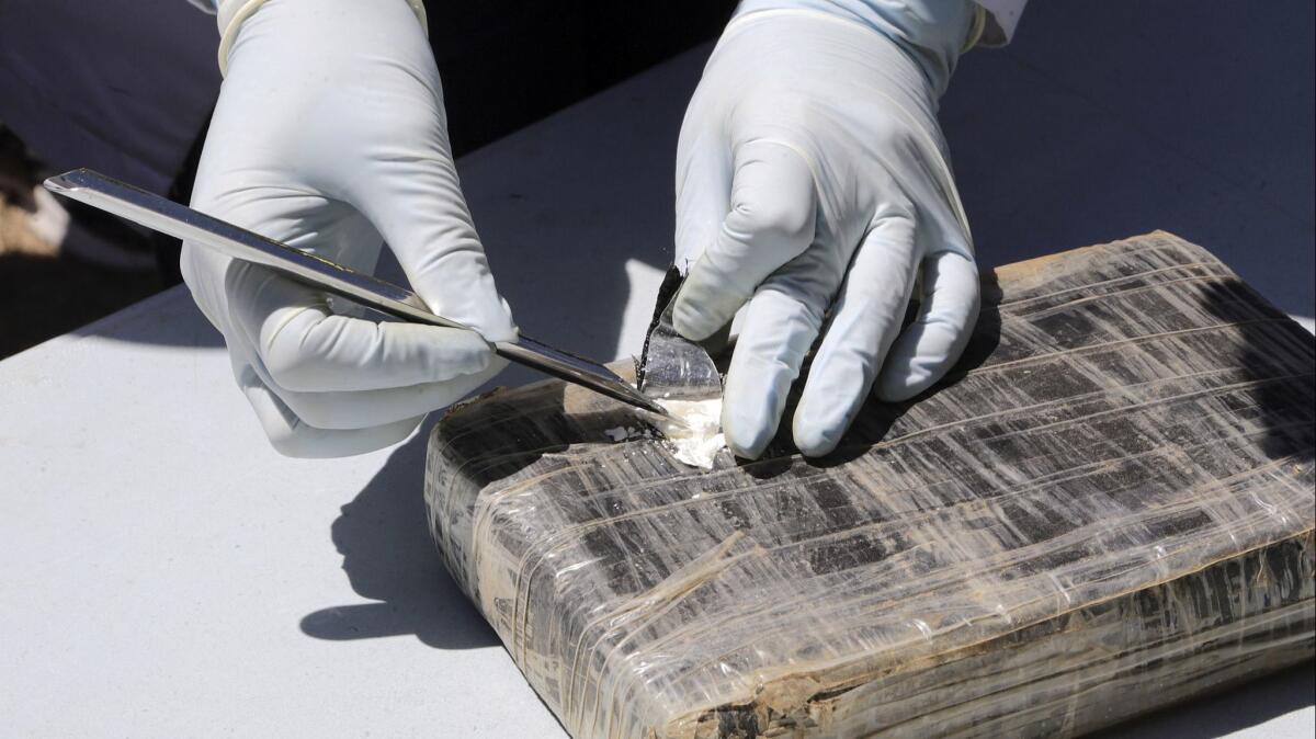 A package of cocaine is opened prior to its destruction in this March 1 photo. A Juarez drug cartel leader has been sentenced for a scheme involving more than a ton of cocaine.