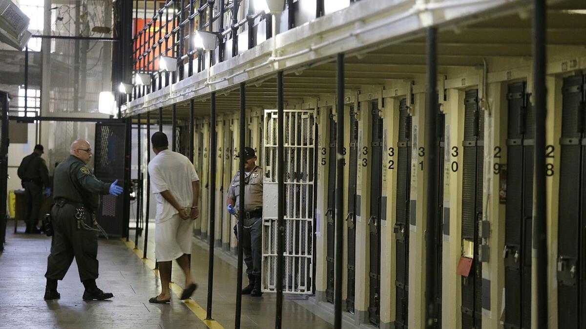 A condemned inmate is led out of his cell on death row at San Quentin State Prison in 2016.