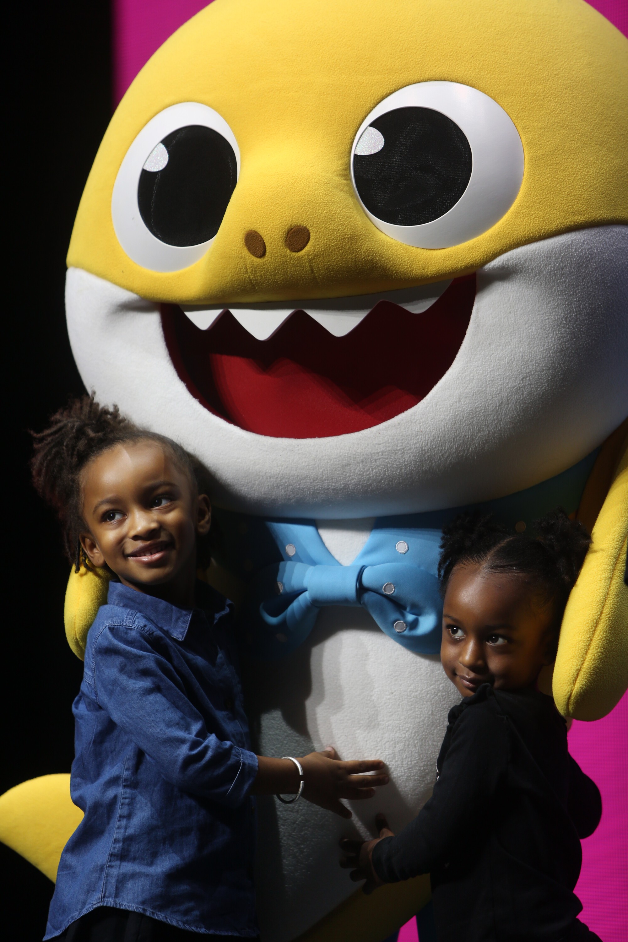 Anaiah, left, and Zariah Lafond get a baby shark hug