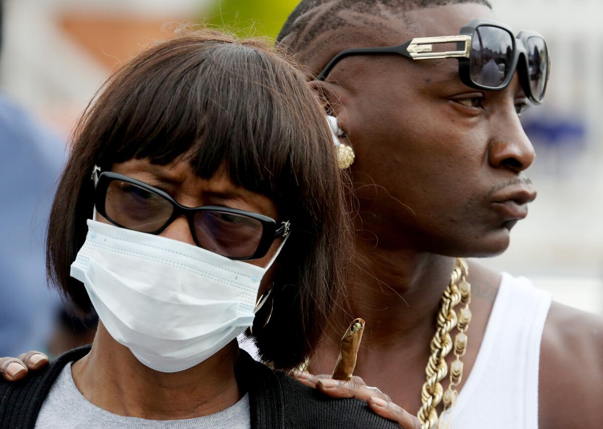 Fletcher Fair, left, the aunt of Dijon Kizzee, pays a visit to the site where the 29-year-old Black man was shot and killed.