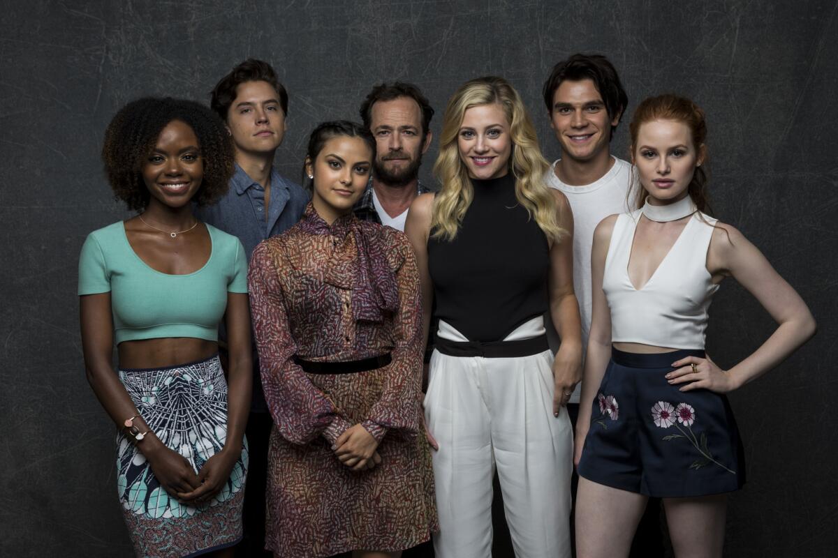 Ashleigh Murray, left, Cole Sprouse, Camilia Mendes, Luke Perry, Lili Reinhart, KJ Apa, Madelaine Petsch of "Riverdale."