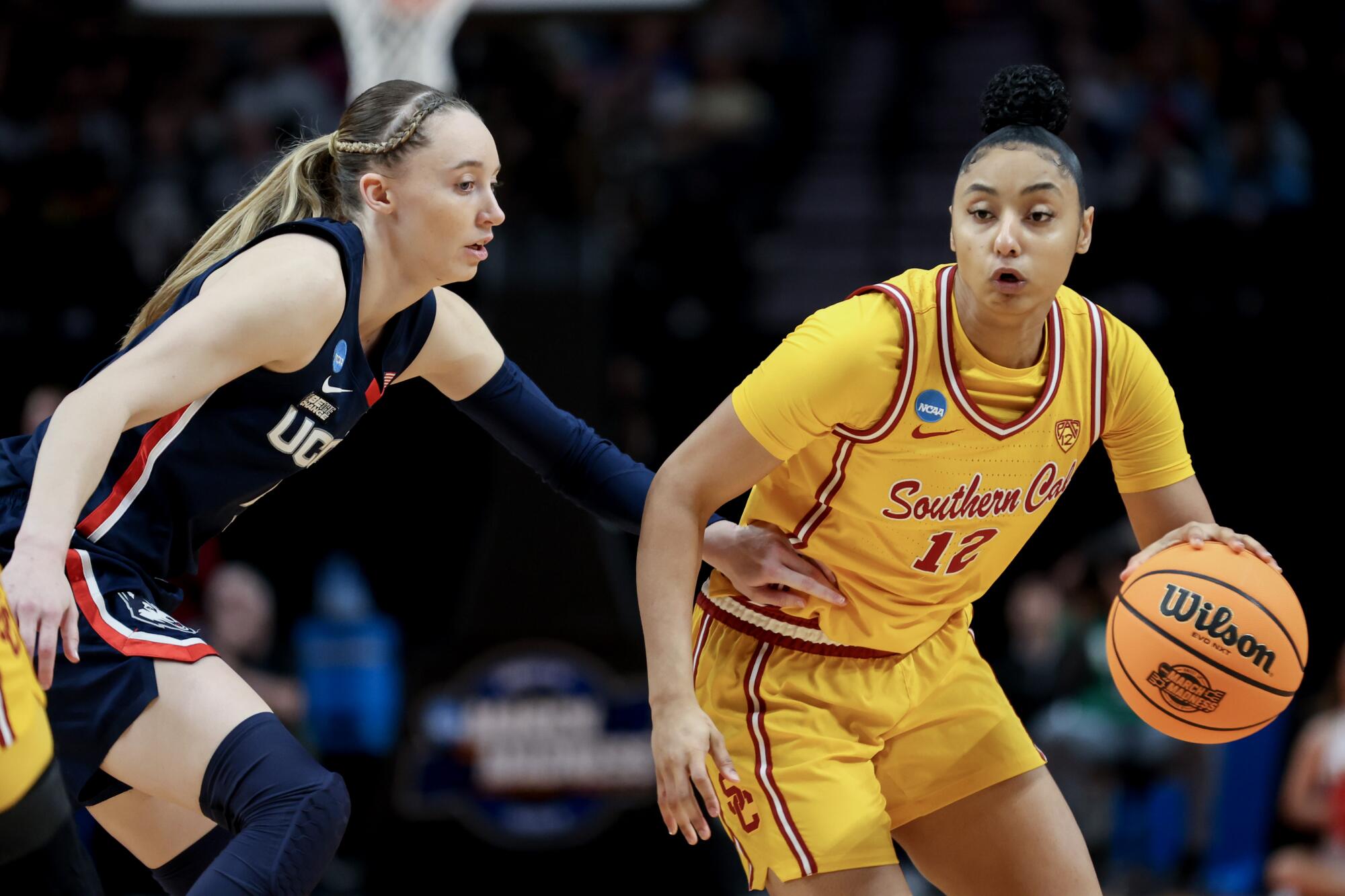USC's JuJu Watkins controls the ball in front of Connecticut's Paige Bueckers.