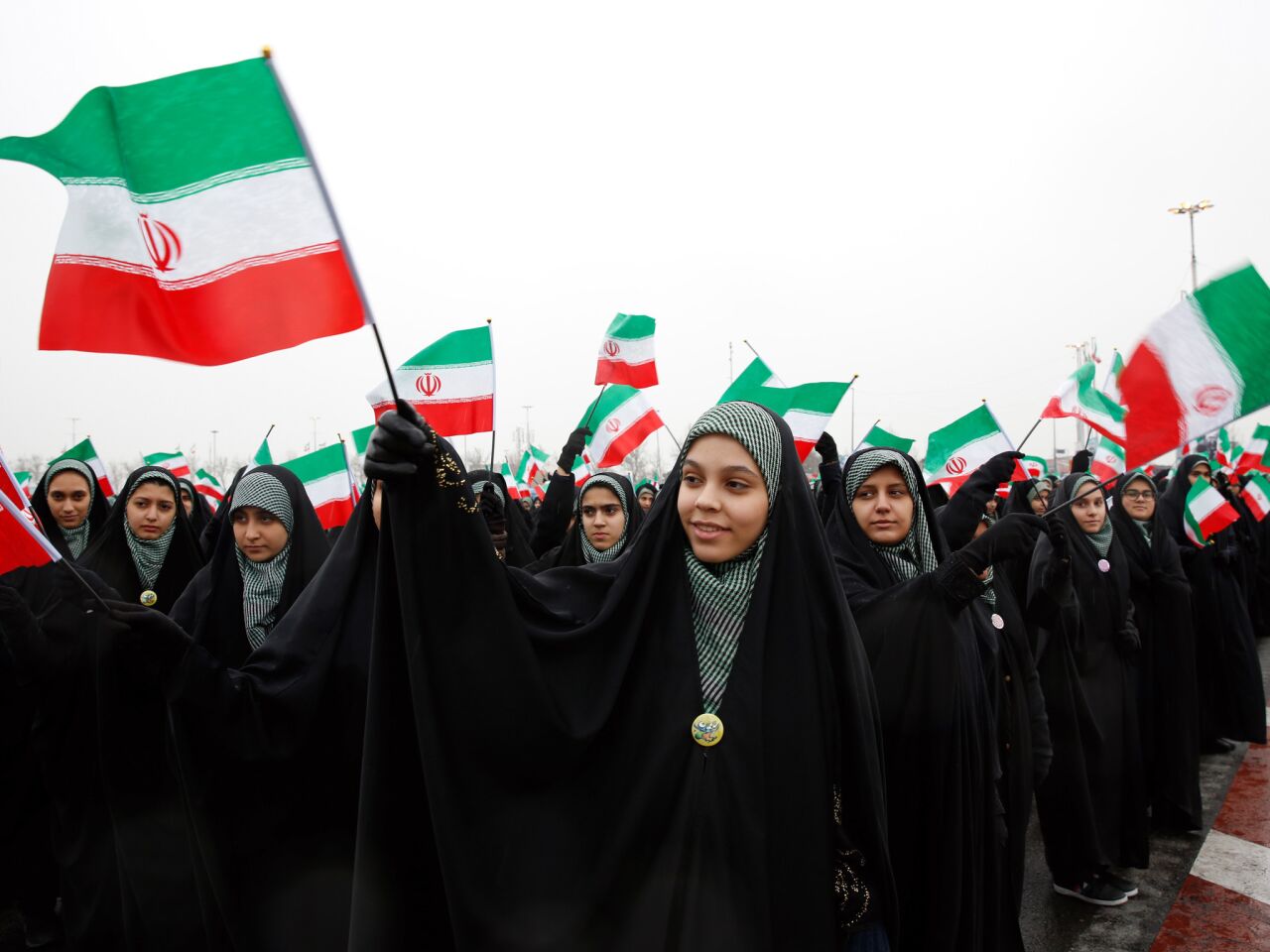 Female students wave Iranian national flags during a ceremony marking the 40th anniversary of the 1979 Islamic Revolution, at the Azadi (Freedom) square in Tehran.