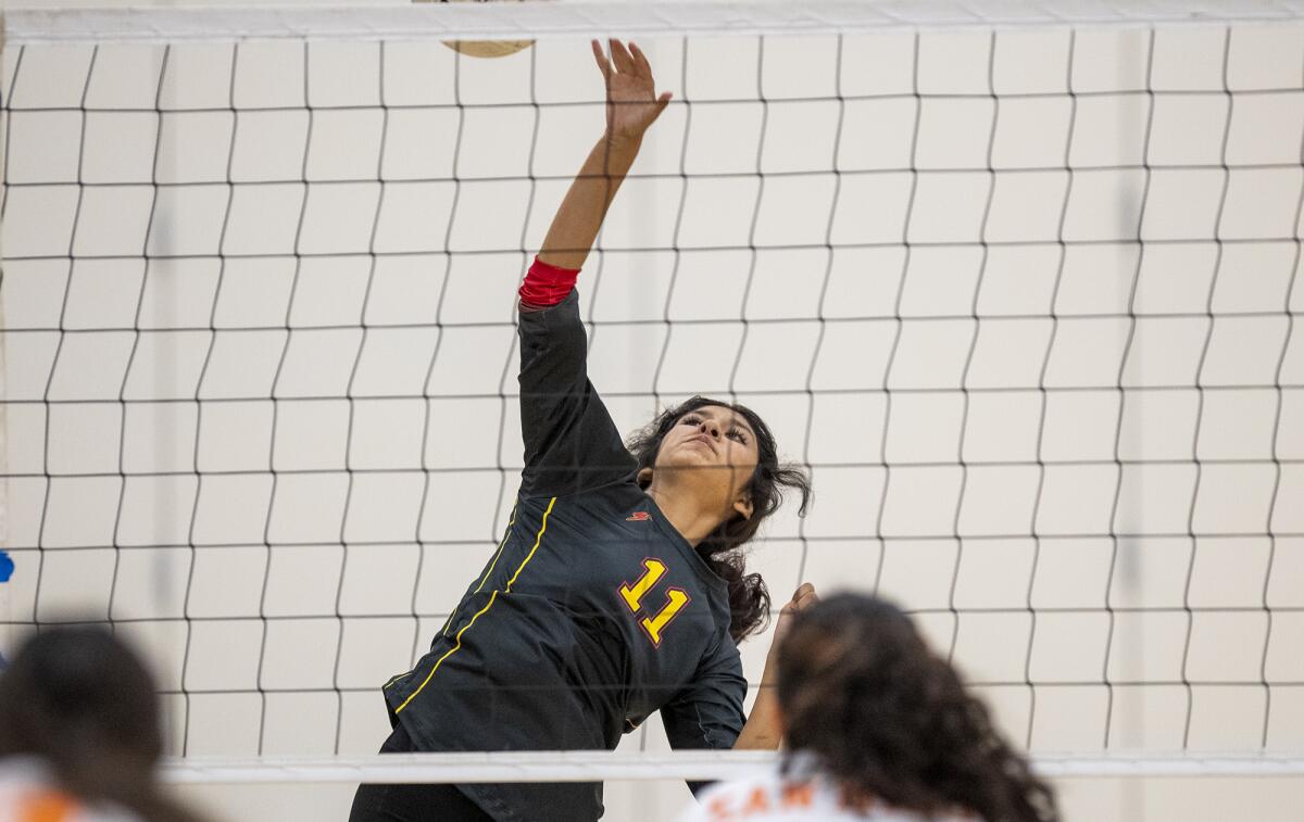 Estancia's Kayden Vazquez hits a ball at the net during a volleyball match against Los Amigos on Thursday.