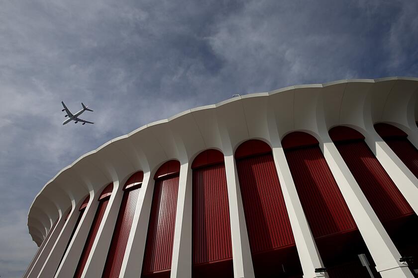 A plane flies over the Forum in Inglewood, which has recently undergone major renovations as new ownership and management strive to make the famed facility the premier live music venue in Southern California.