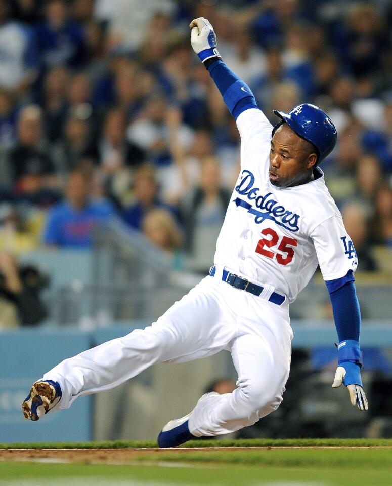Dodgers left fielder Carl Crawford scores against the Giants on a passed ball in the first inning Wednesday night at Dodger Stadium.