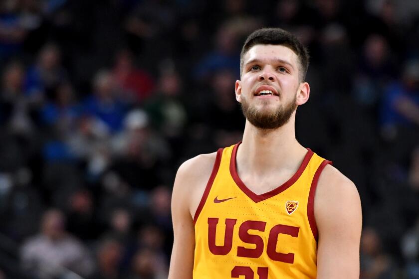 LAS VEGAS, NV - MARCH 09: Nick Rakocevic #31 of the USC Trojans smiles after teammate Elijah Stewart #30 dunked against the Oregon Ducks during a semifinal game of the Pac-12 basketball tournament at T-Mobile Arena on March 9, 2018 in Las Vegas, Nevada. The Trojans won 74-54. (Photo by Ethan Miller/Getty Images)