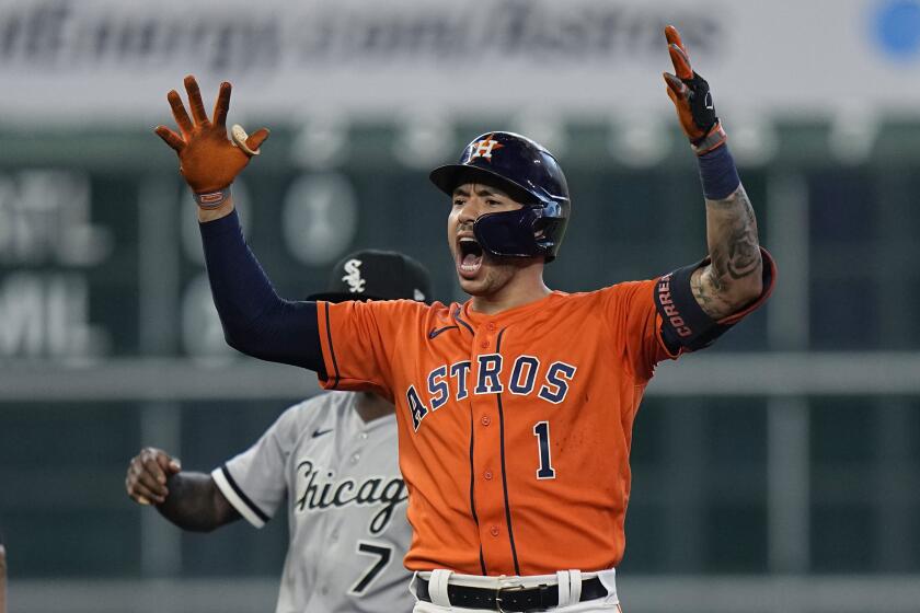 The Houston Astros' Carlos Correa celebrates after hitting a two-run double against the Chicago White Sox on Oct. 8, 2021.