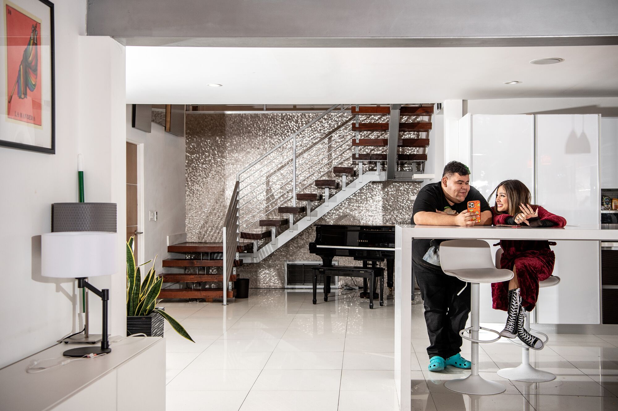 Jesus Zapien, Isabella Ferregur sit in their kitchen.