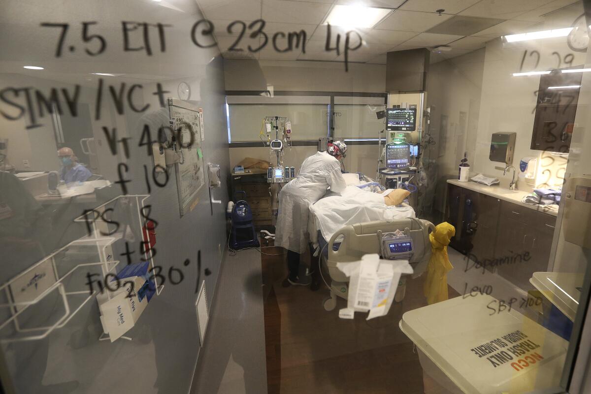 A nurse cares for a patient in the COVID-19 intensive care unit at a Bakersfield hospital.