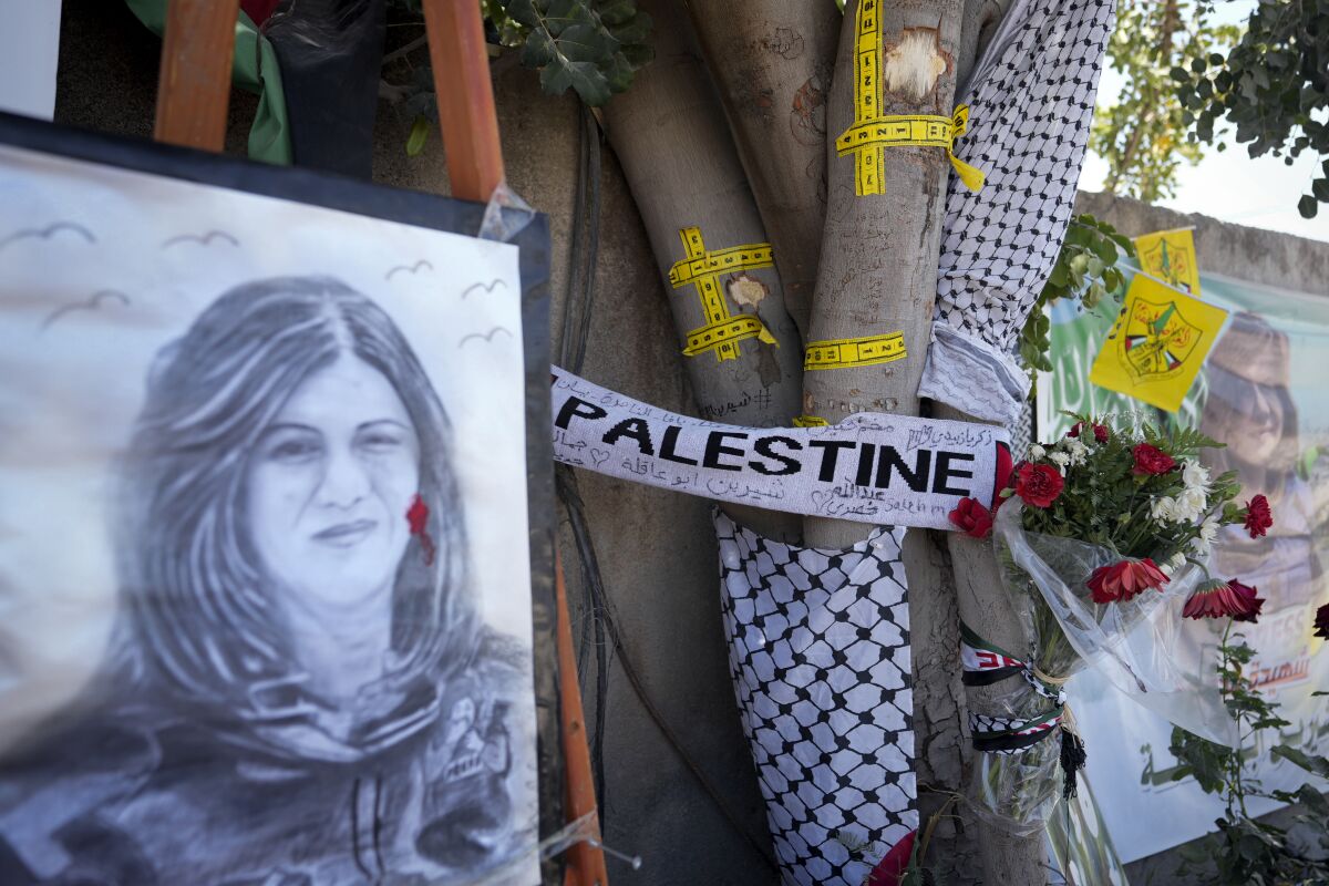 Poster of Al Jazeera journalist Shireen Abu Akleh at a makeshift memorial