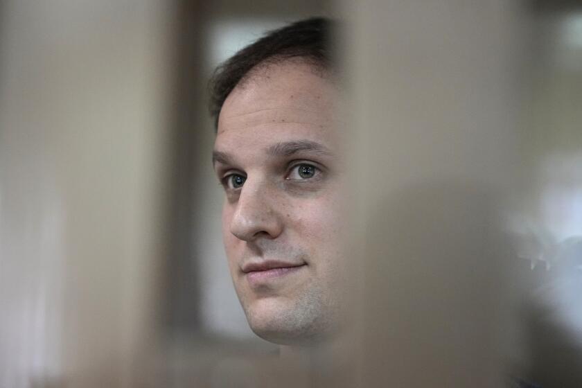 FILE - Wall Street Journal reporter Evan Gershkovich stands in a glass cage in a courtroom at the Moscow City Court in Moscow, Russia, Tuesday, Oct. 10, 2023. A court in Moscow on Tuesday, Nov. 28, extended the detention of Wall Street Journal reporter Gershkovich, arrested on espionage charges, until Jan. 30, Russian news agencies reported. (AP Photo/Alexander Zemlianichenko, File)