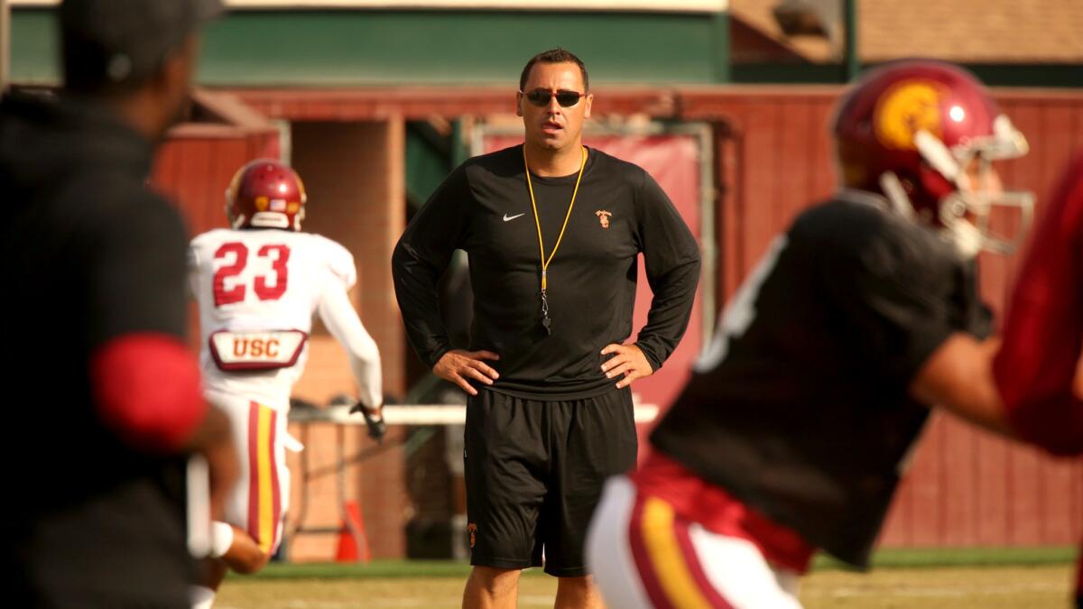 USC Coach Steve Sarkisian watches players during practice on Tuesday after speaking to the media about his behavior at a kickoff event on campus over the weekend.