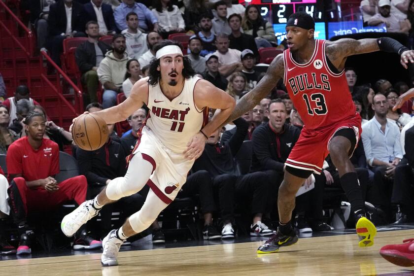 Heat guard Jaime Jaquez Jr. drives to the basket past Bulls forward Torrey Craig 