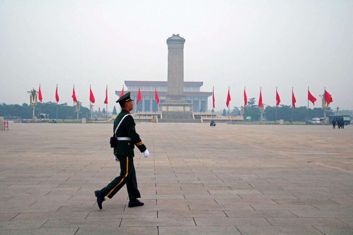 Chinese soldier patrolling Tiananmen Square in Beijing