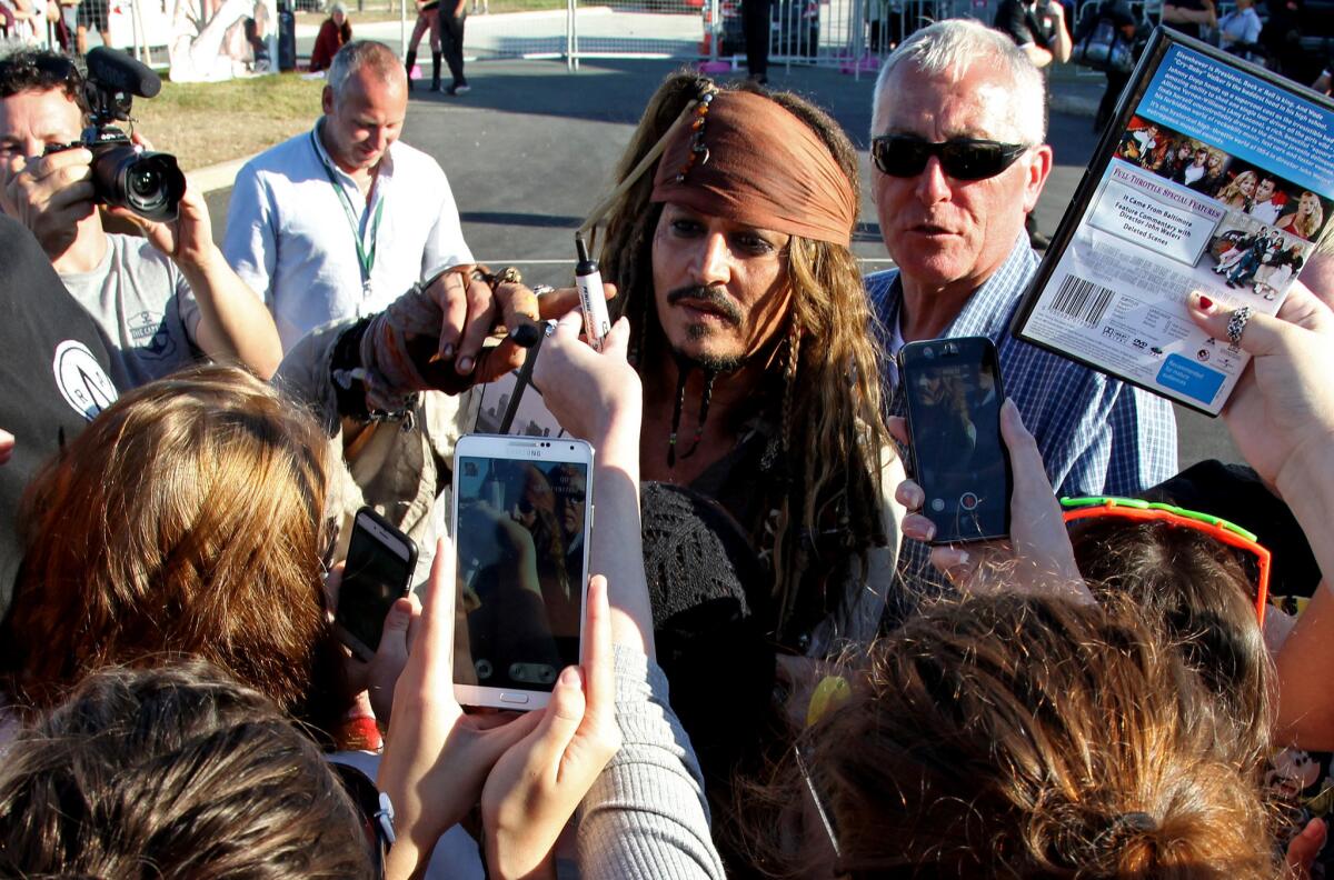 Johnny Depp, in costume as Captain Jack Sparrow, greets Australian fans after a day on the set filming the fifth movie in the "Pirates of the Caribbean" series on June 4, 2015.