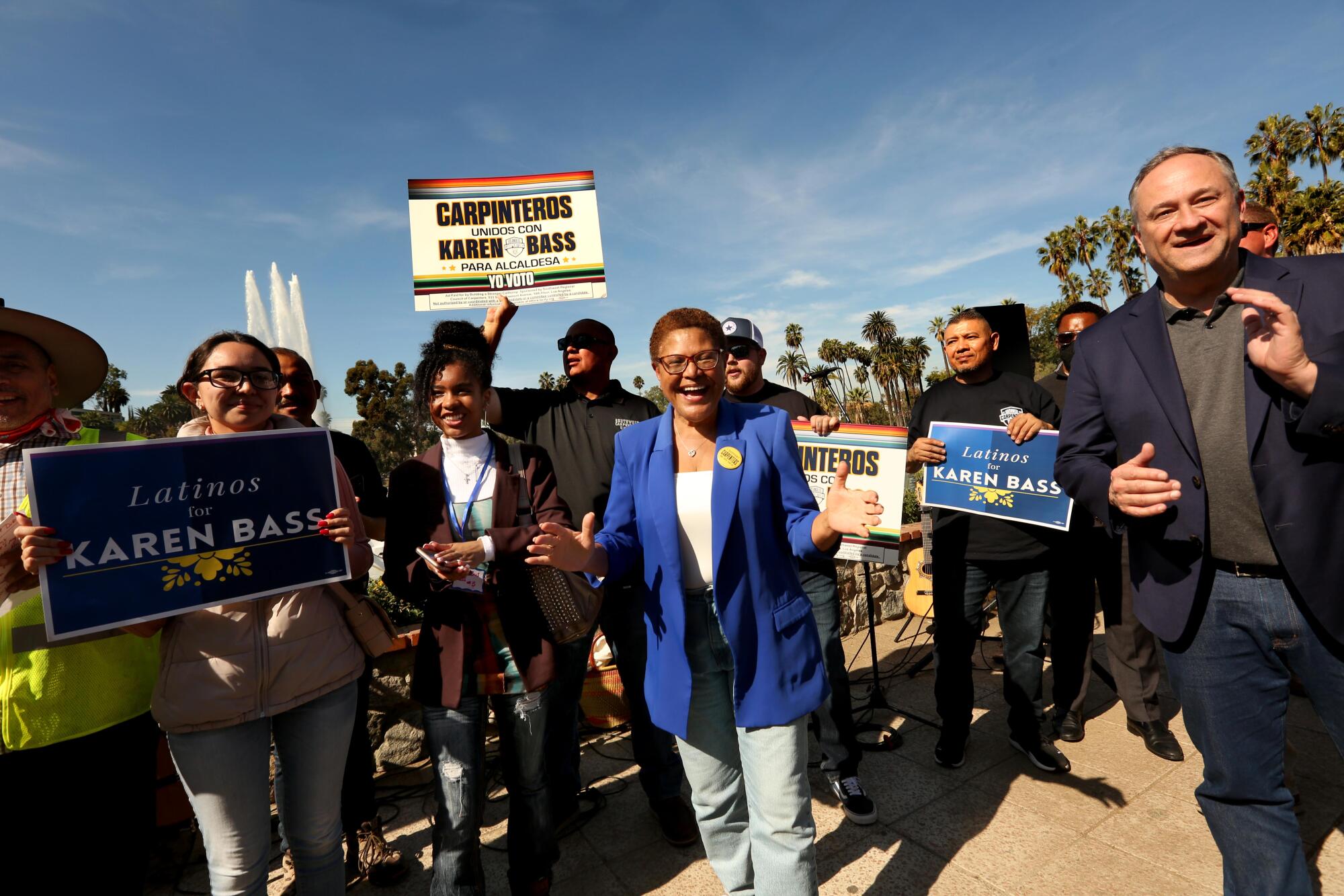 Rep. Karen Bass, center, in a crowd of people holding signs