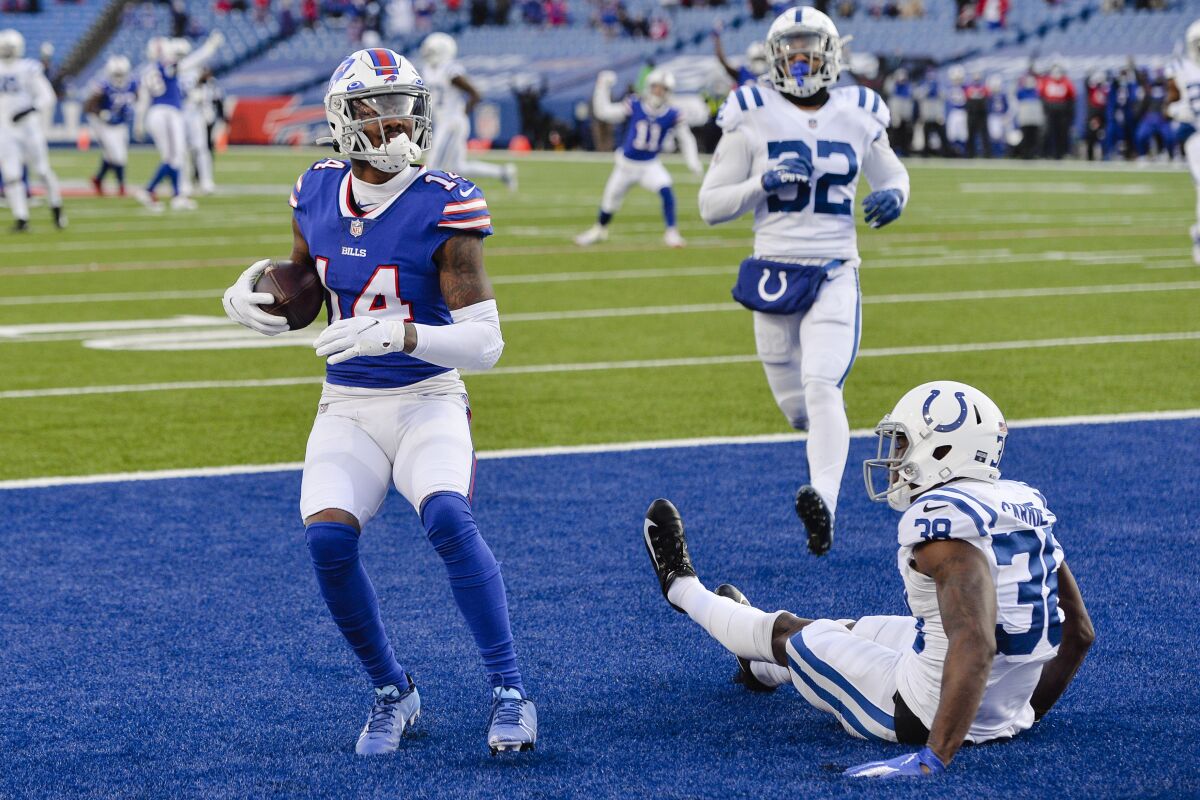 Buffalo Bills' Stefon Diggs (14) reacts after catching a pass in front of Indianapolis Colts' T.J. Carrie (38) during the second half of an NFL wild-card playoff football game Saturday, Jan. 9, 2021, in Orchard Park, N.Y. (AP Photo/Adrian Kraus)
