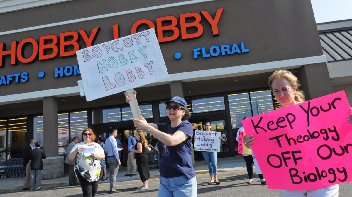Protesters target a Hobby Lobby in Totowa, N.J. after a Supreme Court ruling boosted the control some businesses have over worker health plans in July of 2014.