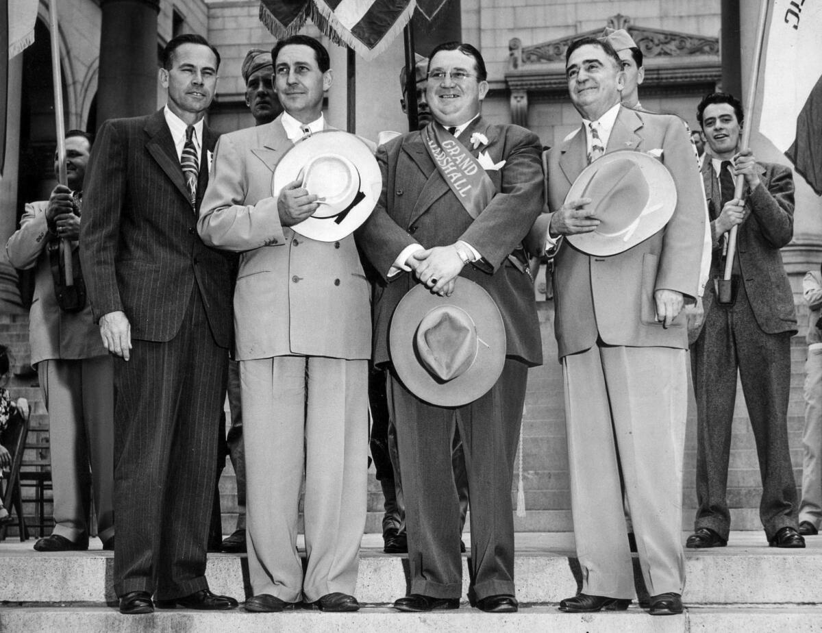 Sept. 2, 1946: On the Labor Day parade reviewing stand at Los Angeles City Hall are, from left: W.J. Bassett, secretary-treasurer of the Central Labor Council; Dist. Atty. Fred Howser; D.D. McClurg, grand marshal of the A.F.L. parade; and Sheriff Eugene Biscailuz.