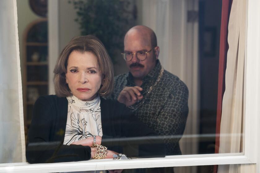 Jessica Walter and David Cross peering out of a window in "Arrested Development."