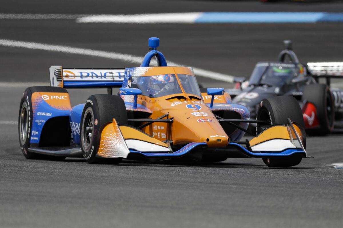 Scott Dixon drives through a turn during the IndyCar Grand Prix race at Indianapolis Motor Speedway on Saturday.