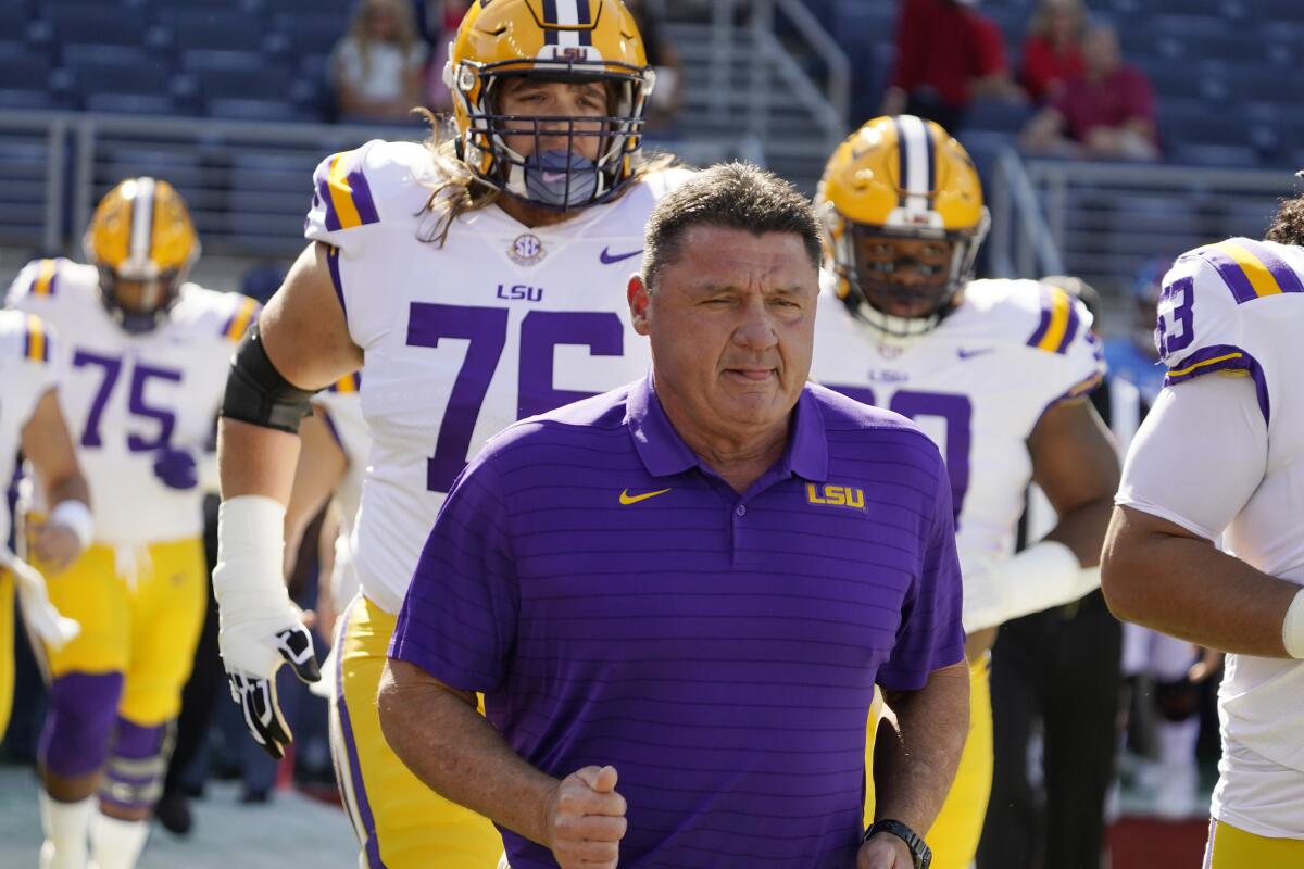 LSU coach Ed Orgeron leads his team to the field before a loss to Mississippi on Oct. 23.
