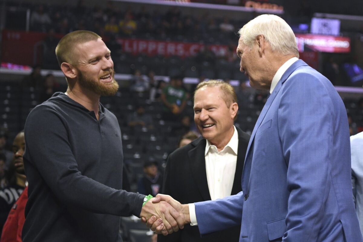Stephen Strasburg, left, and agent Scott Boras, center, greet Los Angeles Clippers executive Jerry West before the Clippers played the Houston Rockets on Nov. 22.