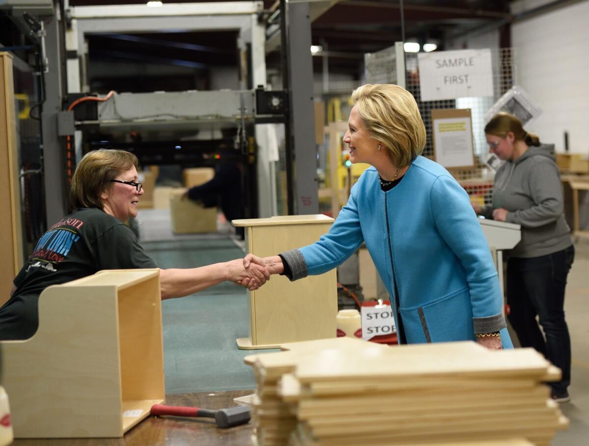 Hillary Clinton tours a New Hampshire furniture factory before holding a roundtable discussion with its workers.