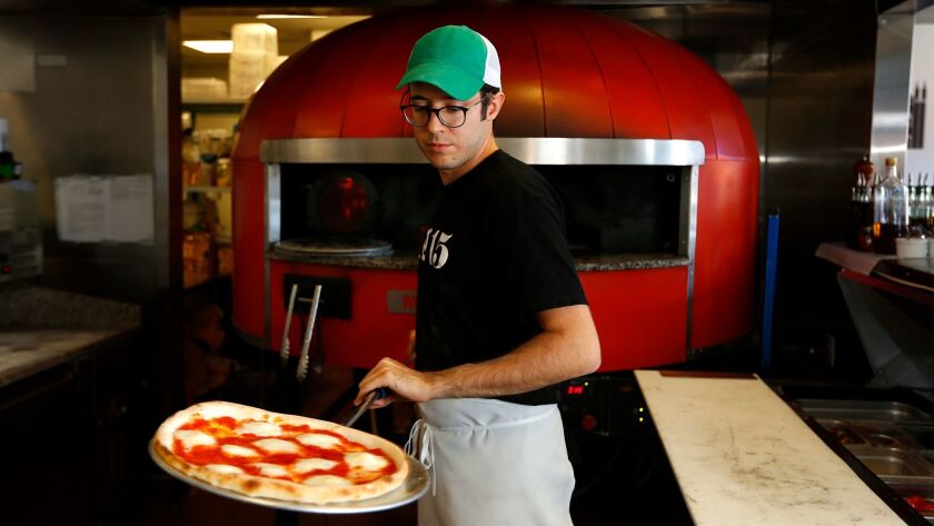 In this 2017 photo, Andrea Burrone made a margherita pizza at the original Ambrogio15 in Pacific Beach.