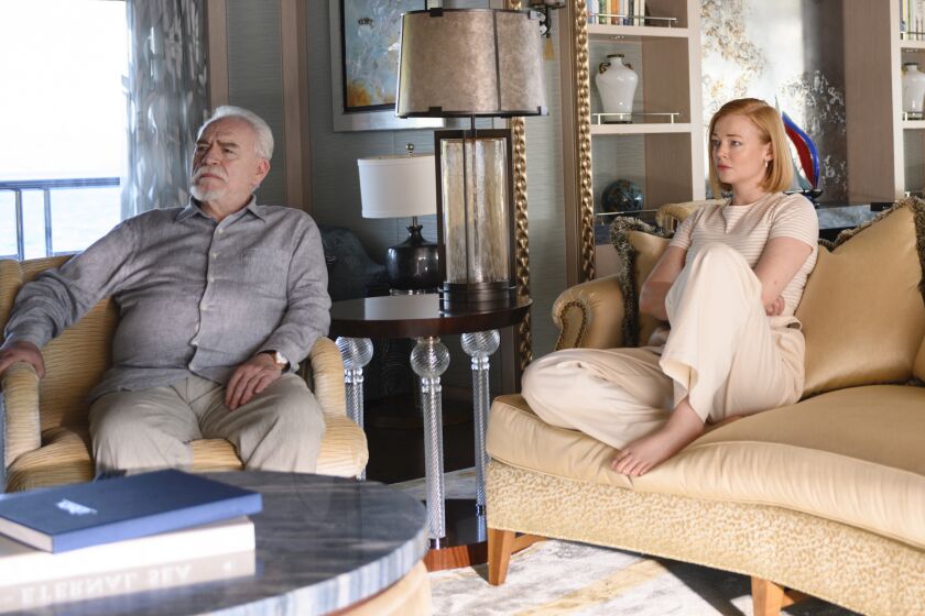 Logan (Brian Cox) and Shiv (Sarah Snook) sit down to watch Kendall's press conference in the Season 2 finale of "Succession."