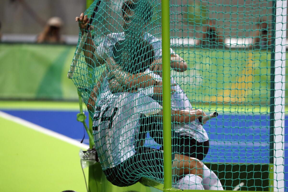 Players from Argentina celebrate inside the net cage after beating Belgium during a men's field hockey gold medal match at the 2016 Summer Olympics in Rio de Janeiro, Brazil, Thursday, Aug. 18, 2016. (AP Photo/Dario Lopez-Mills)