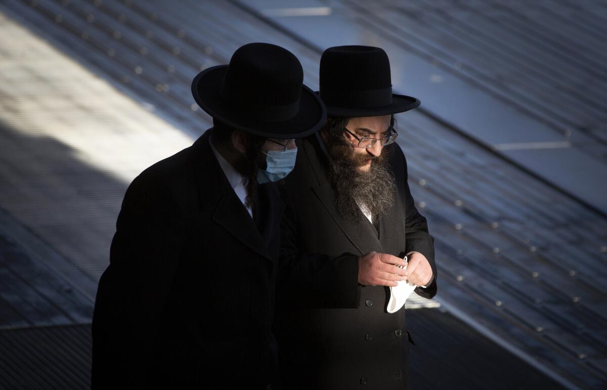 Two ultra-Orthodox Jewish men walking.