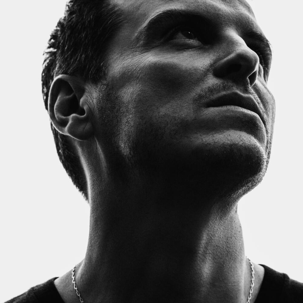 Andrew Scott looks up at an angle in a black-and-white portrait