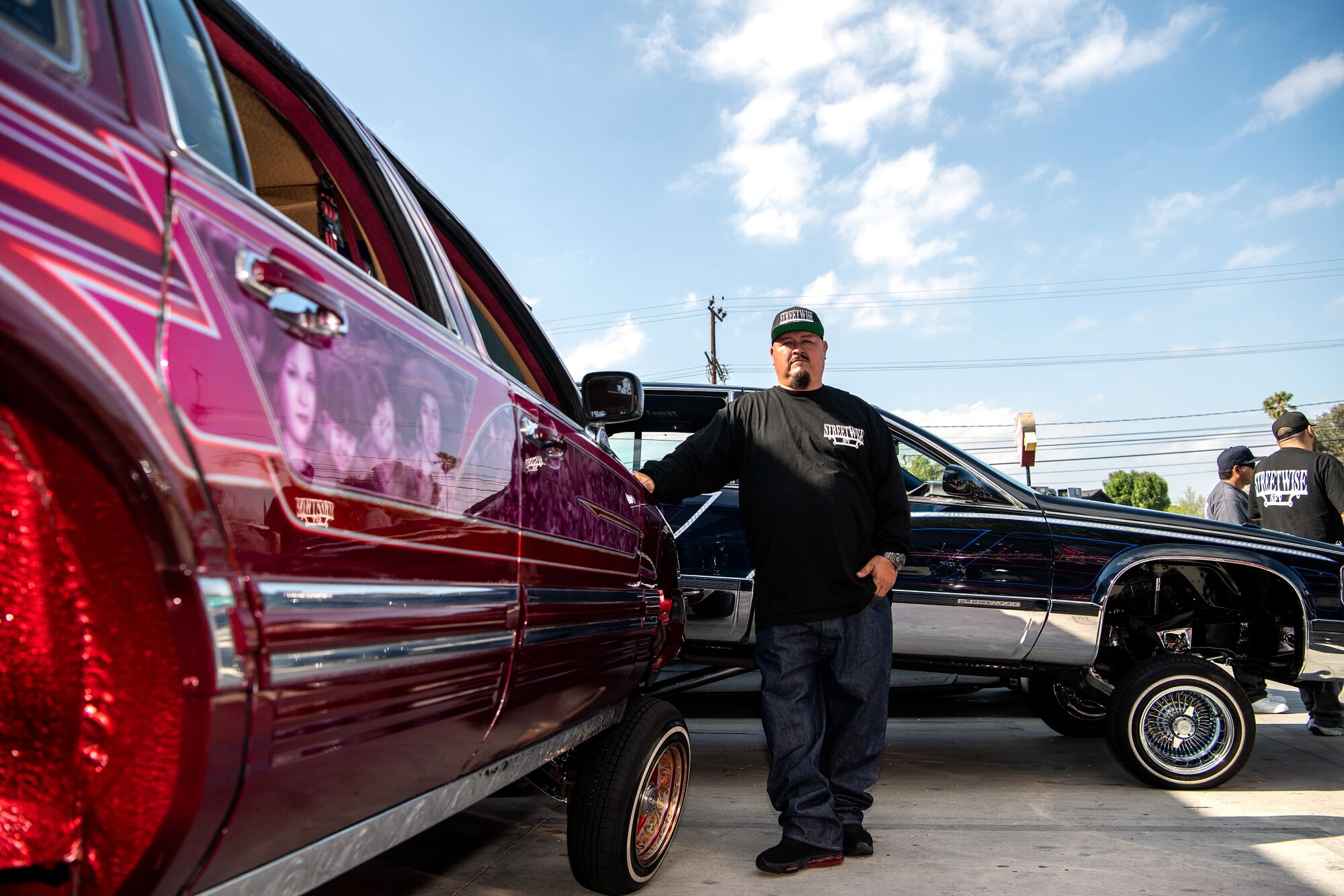 Joe Arevalo poses with his 1991 Lincoln Town Car