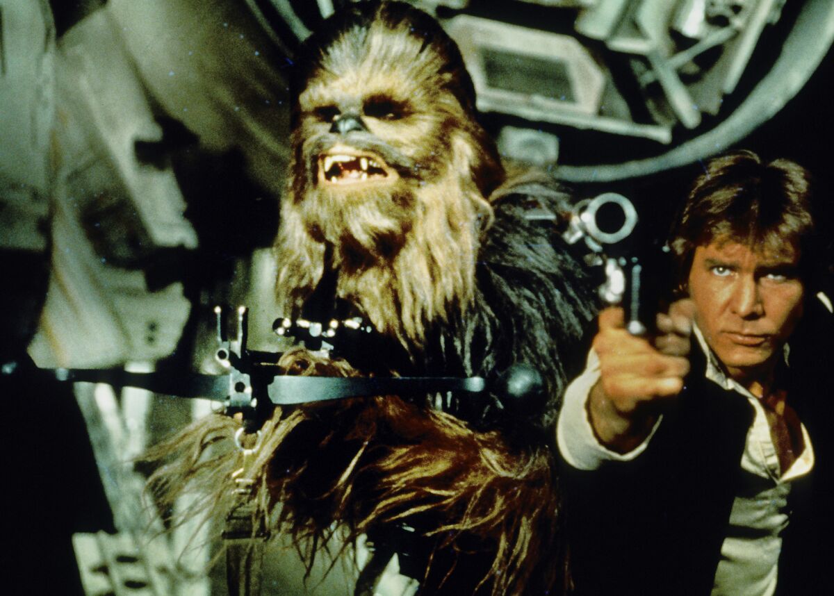 Peter Mayhew as Chewbacca, with Harrison Ford as Han Solo in "Star Wars," is reprising his Wookiee role in "Star Wars: Episode VII."