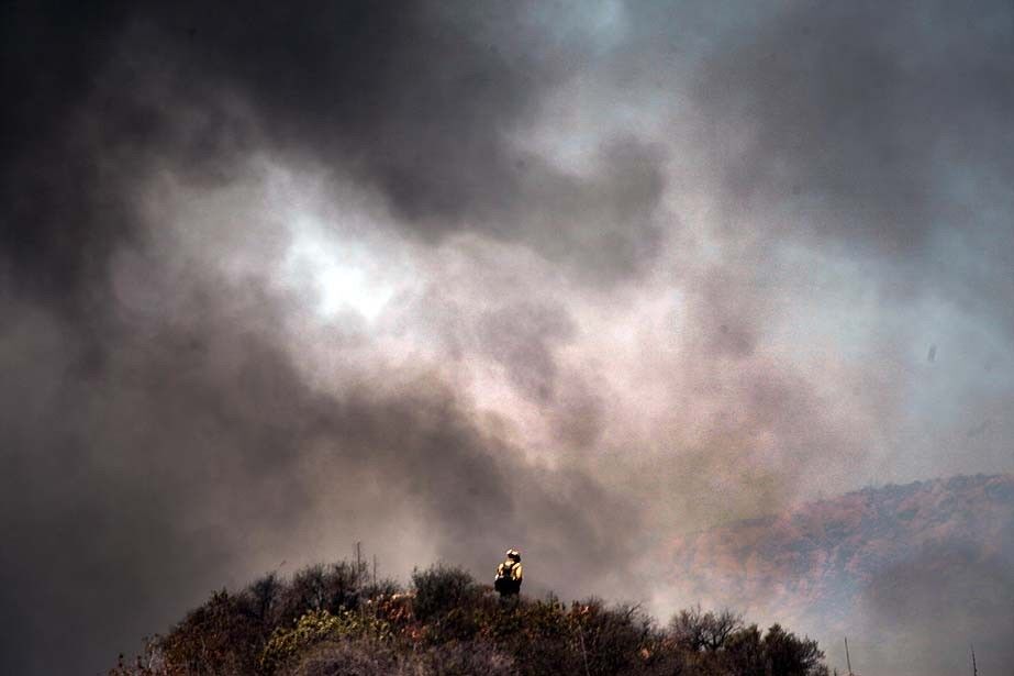 Firefighters worked to contain the Springs fire, being fueled by dry Santa Ana winds and warm temperatures.