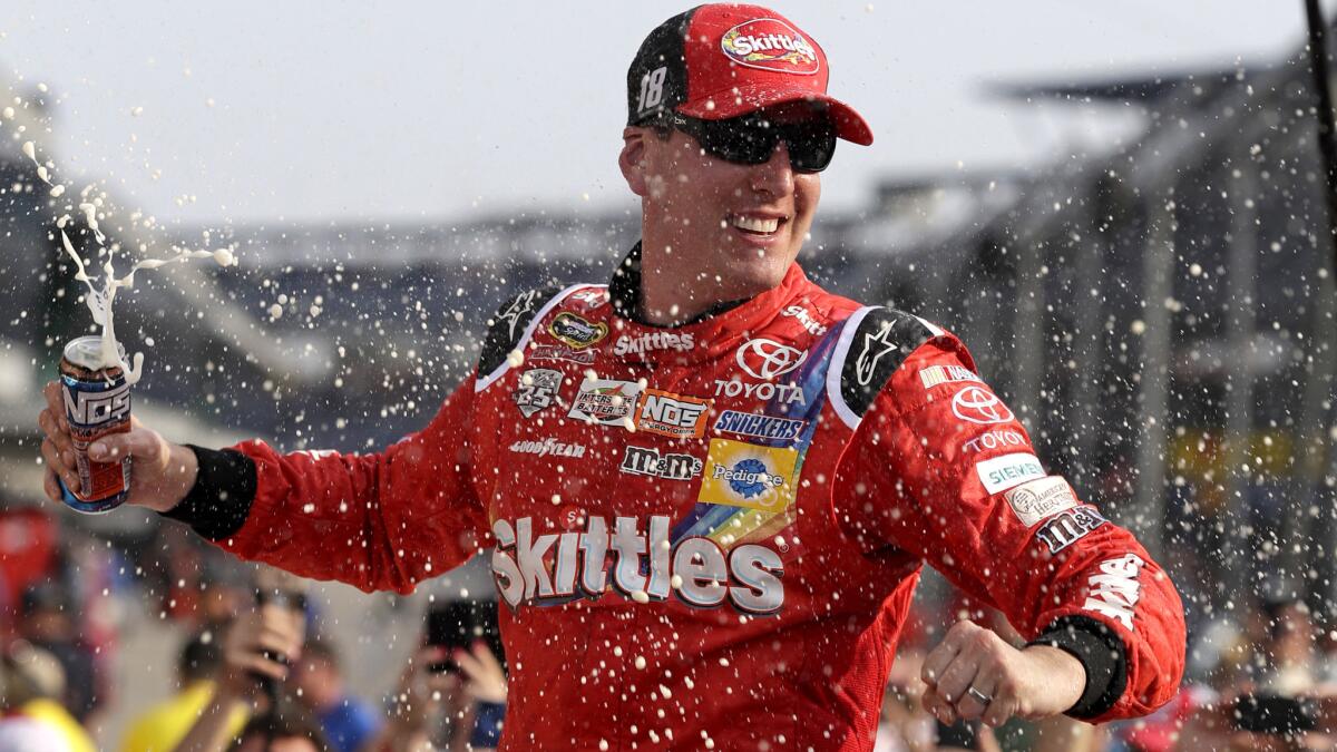 NASCAR driver Kyle Busch celebrates after winning the Sprint Cup Brickyard 400 at Indianapolis Motor Speedway.
