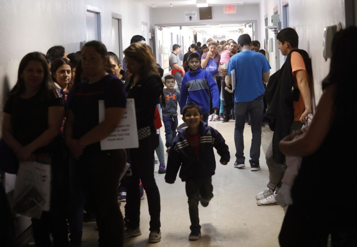 Recently released asylum seekers fill the hallways at the Catholic Charities Humanitarian Respite Center in McAllen, Texas, on Thursday.